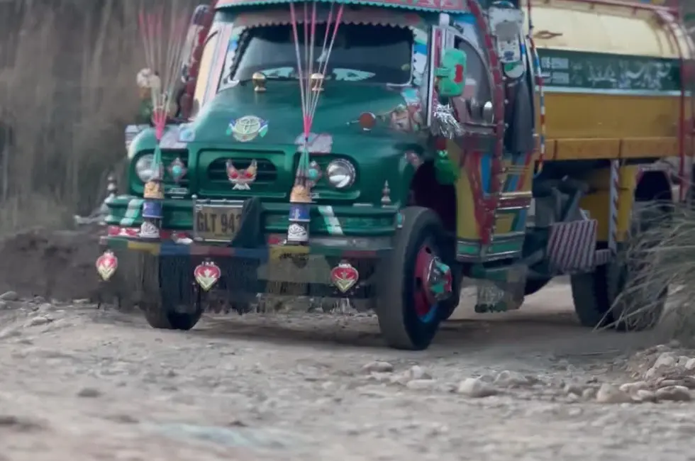 Decorated Pakistani truck approaching on a rural road